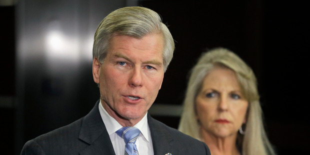 Former Virginia Governor Bob McDonnell makes a statement as his wife, Maureen, listens during a news conference. Photo / AP