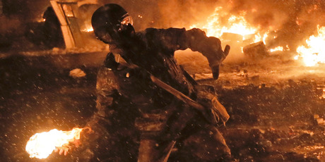 A protester throws a Molotov cocktail during clashes with police in central Kiev. Photo / AP
