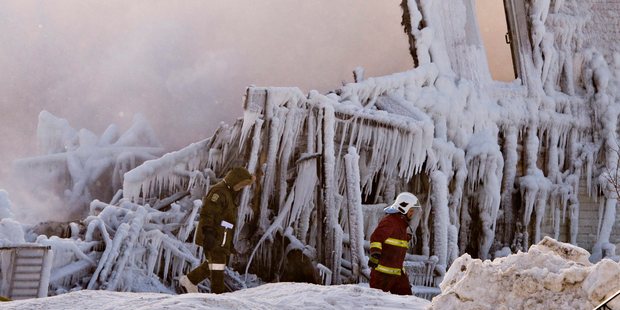 Firefighters continue to work at the scene of a fatal fire at a seniors residence in L'Isle-Verte,Quebec. Photo / AP