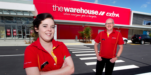The Warehouse says first half profit will fall by as much 13 percent. Emilee Irving, 17 and Kevin Balding get ready for the opening of the Warehouse in Silverdale. Photo / Steven McNicholl