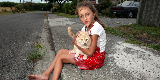 Eight-year-old Aleaha Macalo pictured with her pet cat Lucy after her other pet cat was killed by a neighbourhood dog. Photo/Paul Taylor