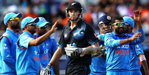 Tim Southee of New Zealand looks on as Indian players celebrate the wicket of Luke Ronchi. Photo / Getty Images