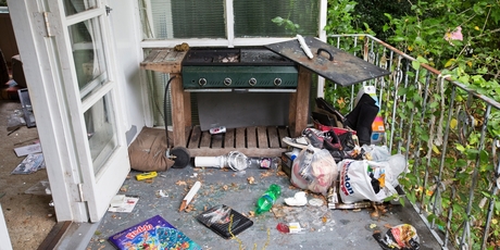Outside, piles of rubbish and an overgrown lawn surround the property. Photo / Greg Bowker