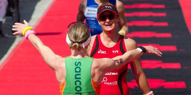 Winner Catriona Morrison, of Great Britain, welcomes home third-placed Jo Lawn in the New Zealander's final ever race. Photo / Richard Robinson