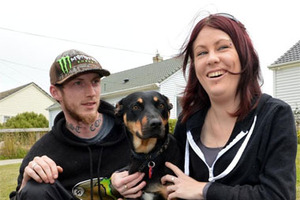 Housing New Zealand tenants Lara Elliott and Shane Wilson with their dog Mischief, who could be evicted. Photo / Stephen Jaquiery
