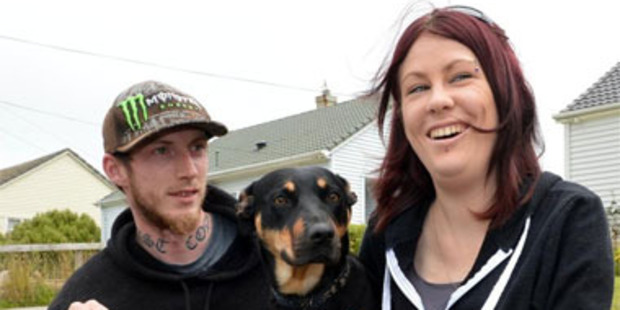 Housing New Zealand tenants Lara Elliott and Shane Wilson with their dog Mischief in Dunedin yesterday. Photo / Stephen Jaquiery