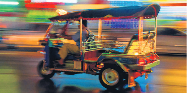 Cheerful and ubiquitous, tuk tuk taxis can carry a family of five - at a squeeze. Best of all, they're cheap. Photo / Getty Images