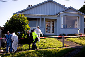 The body of Edward Livingstone is brought out of the house on Kiwi Street in Dunedin. Photo / Dean Purcell