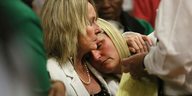 Mother and cousin of the late Reeva Steenkamp, June Steenkamp, left, and Kim Martin, right, comfort one another in court in Pretoria. Photo / AP