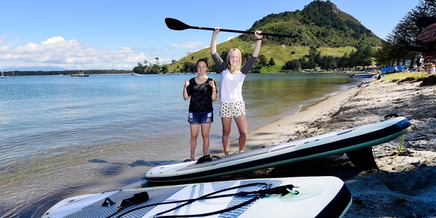 Paulina Lange and Hanna Nedgeard might have got dunked but loved the chance to learn stand up paddle boarding at Pilot Bay. Photo / George Novak