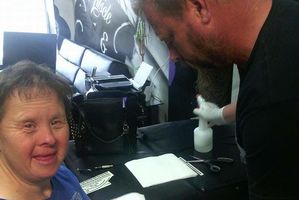 Jason Ward applies a stick on tattoo for Suzie.