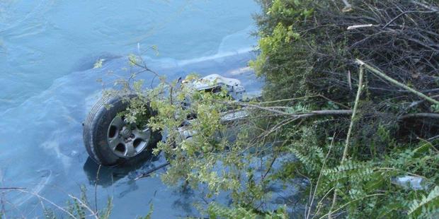 A drive escaped drowning after their car landed upside-down in a river. Photo / APNZ