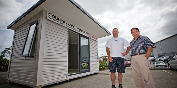 Graeme Reynolds and Dewey Yu of Countrywide Homes show off one of the prefabs. Photo / Greg Bowker