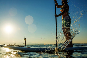 Engage your core and get out on a paddleboard. Photo / Getty Images