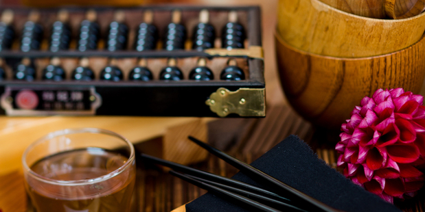 Abacus, wooden board,Leaf & Bean glass teapot, bamboo steamer, chopsticks, wooden bowls and wok from Wah Lee. Photo / Babiche Martens.