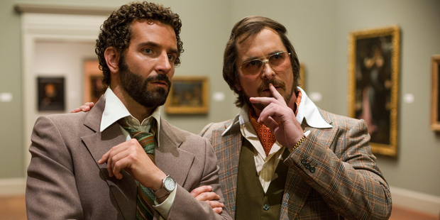 Bradley Cooper, left, as Richie Dimaso and Christian Bale as Irving Rosenfeld talk in a gallery in a scene from 'American Hustle.' Photo / Sony Pictures