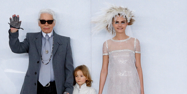 Cara Delevingne's goofy grin at the Chanel couture show, with Karl Lagerfeld and Hudson Kroenig. Photo / AP Images