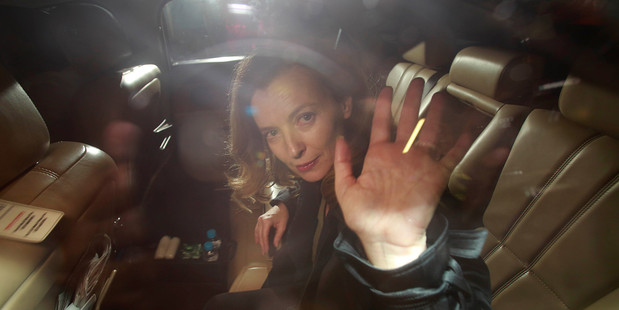 Valerie Trierweiler, former partner of French President Francois Hollande, waves to media as she leaves an airport in India. Photo / AP