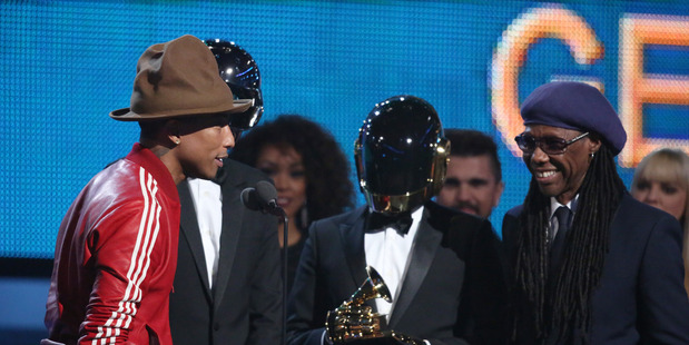 Pharrell Williams, from left, Daft Punk and Nile Rodgers accept the award for best pop duo/group performance at the 56th annual Grammy Awards in Los Angeles.