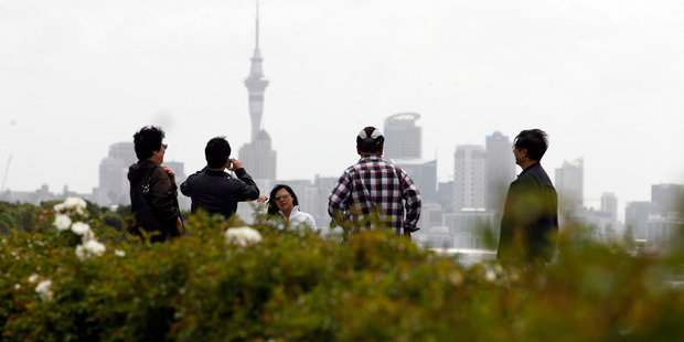 Asian tourists take in the sites of Auckland City from Bastion Point. Photo / Dean Purcell