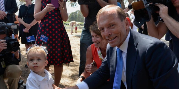 Australian Prime Minister Tony Abbott meets a young Australian at an Australia Day ceremony on Sunday.