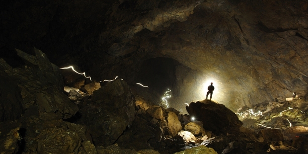 Kieran Mckay is dwarfed in a huge Stormy Pot-Nettlebed cave. Photo / Jonathon Ravens