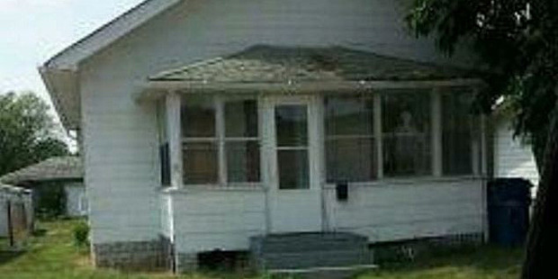 A figure is visible in the window of the Hammond house allegedly haunted by demons. Photo / Hammond Police Department