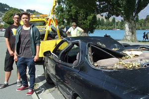 Nico Reiner (left) and Paul Zeller from Germany, say they are out of pocket after a tree in a Queenstown Lakes District Council park fell and crushed their car. Photo / Christina McDonald.