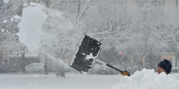 A man battles to clear a street in Wiesbaden, southwest Germany. More than 20cm of snow has fallen in some areas of the Black Forest. Photo / AP