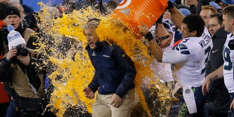 Seattle quarterback Russell Wilson (3) showers head coach Pete Carroll with Gatorade. Photo / AP