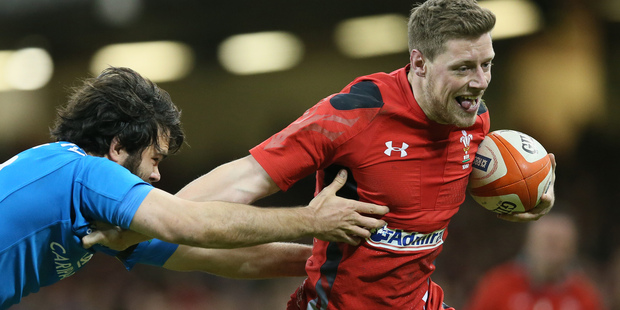 Wales's Rhys Priestland, right, gets away from Italy's Luke McLean. Photo / AP