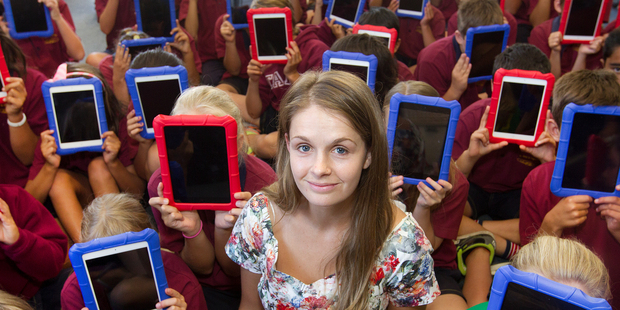 Teacher Monique Storey is surrounded by a class full of iPads after students were given their own iPad at Te Akau ki Primary School in Papamoa. Photo / Alan Gibson