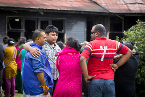 Family mourn after a fire gutted their home in Mangere East today. Photo / Sarah Ivey