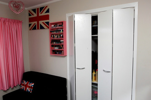Bi-fold wardrobe doors are a good way to maximise space. Photo / Michael Craig