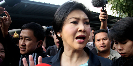 Thai Prime Minister Yingluck Shinawatra leaves a polling station after casting her ballot for the general election in Bangkok. Photo / AP