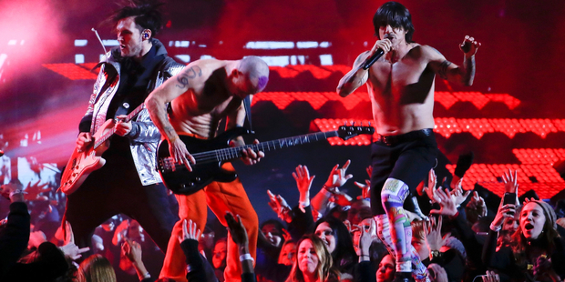 The Red Hot Chili Peppers perform during the halftime show, without their instruments plugged in. Photo / AP