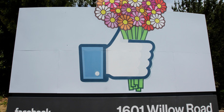 Flowers are added to a Facebook sign in front of Facebook headquarters in Menlo Park, California. Photo / AP
