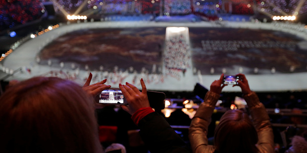 A spectator takes a video of the opening ceremony on her mobile phone at the 2014 Winter Olympics in Sochi, Russia. Photo / AP