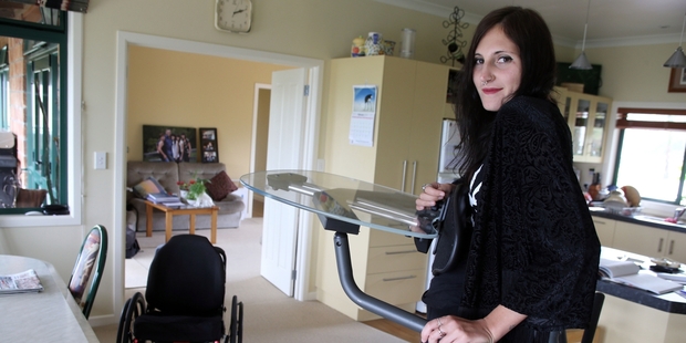 UPRIGHT: Whangarei tetraplegic Alicia Kissick (pictured at home in her standing frame) is flying to Christchurch this weekend for an operation to transfer muscles from her forearms into her hands, a procedure which is now funded by ACC.
PHOTO/JOHN STONE