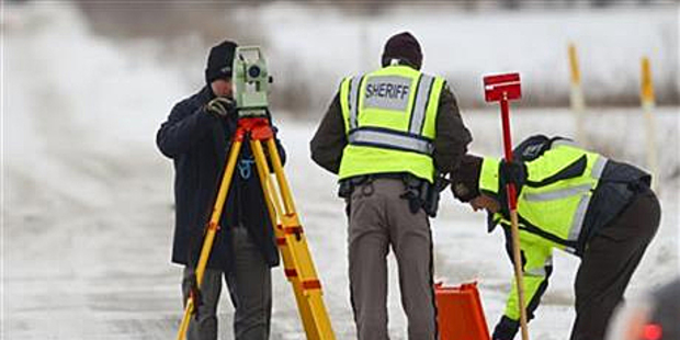 Officers from the St. Clair County Sheriff's Department investigate a scene where bags of human remains were discovered. Photo / AP