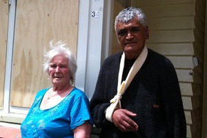 Frank and Barbara Watene standing outside bordered up windows at their Naenae home. Photo / Rebecca Quilliam