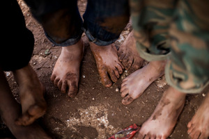 Displaced Syrian children gather barefoot in a refugee camp near Atma, Idlib province, Syria. Photo / AP