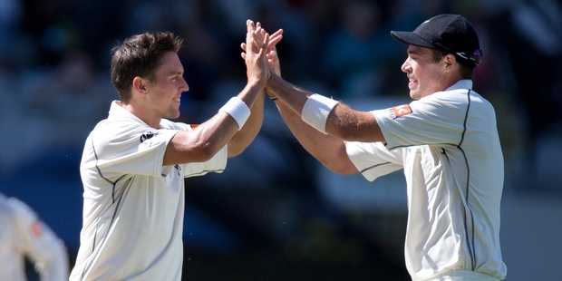 New Zealand bowlers Trent Boult (left) and Tim Southee celebrate a wicket yesterday. Photo / Brett Phibbs
