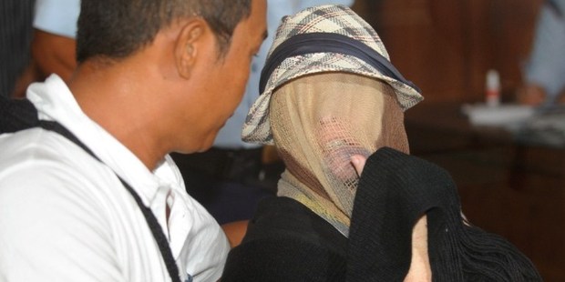 Schapelle Corby's face was covered as she sat at a correction bureau in Denpasar. Photo / AFP