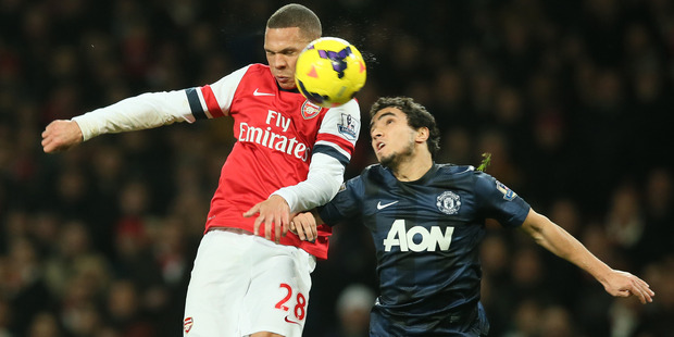 Arsenal's Kieran Gibbs, left, challenges for the ball as he out jumps Manchester United's Rafael during their English Premier League soccer match. Photo / AP