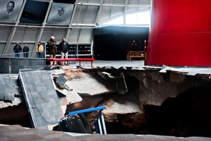 Officials view a sinkhole that opened up in the Skydome showroom, at the National Corvette Museum in Bowling Green, Ky. Eight display cars were swallowed by the hole. Photo / AP