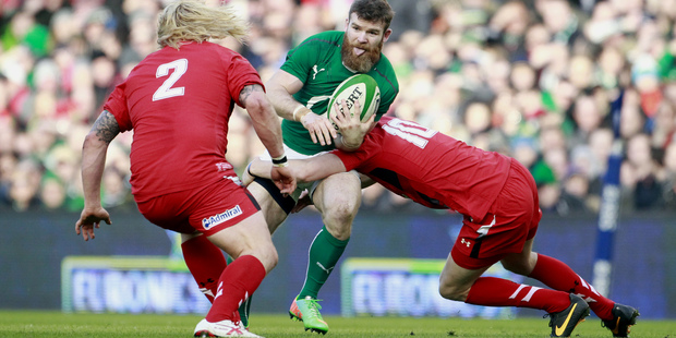 Ireland's Gordon D'Arcy, center, is tackled by Wales' Rhys Priestland, right, and Richard Hibbard, left, during their Six Nations Rugby Union international match at the Aviva Stadium. Photo / AP