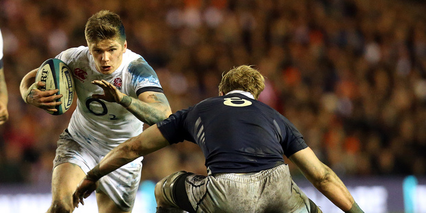 England's Owen Farrell, left, is tackled by Scotland's David Denton, right, during their Six Nations rugby union international match at Murrayfield, Edinburgh, Scotland. Photo / AP