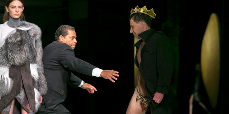 A streaker in a G-string is chased by security, during Fashion Week. Photo / AP