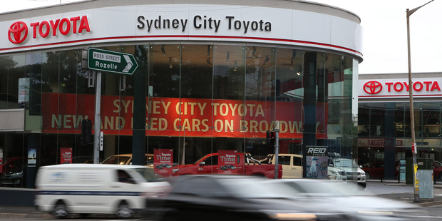 Vehicles speed past a Toyota dealership in Sydney, Monday, Feb. 10, 2014. Toyota announced it will stop making cars in Australia by the end of 2017. Photo / AP